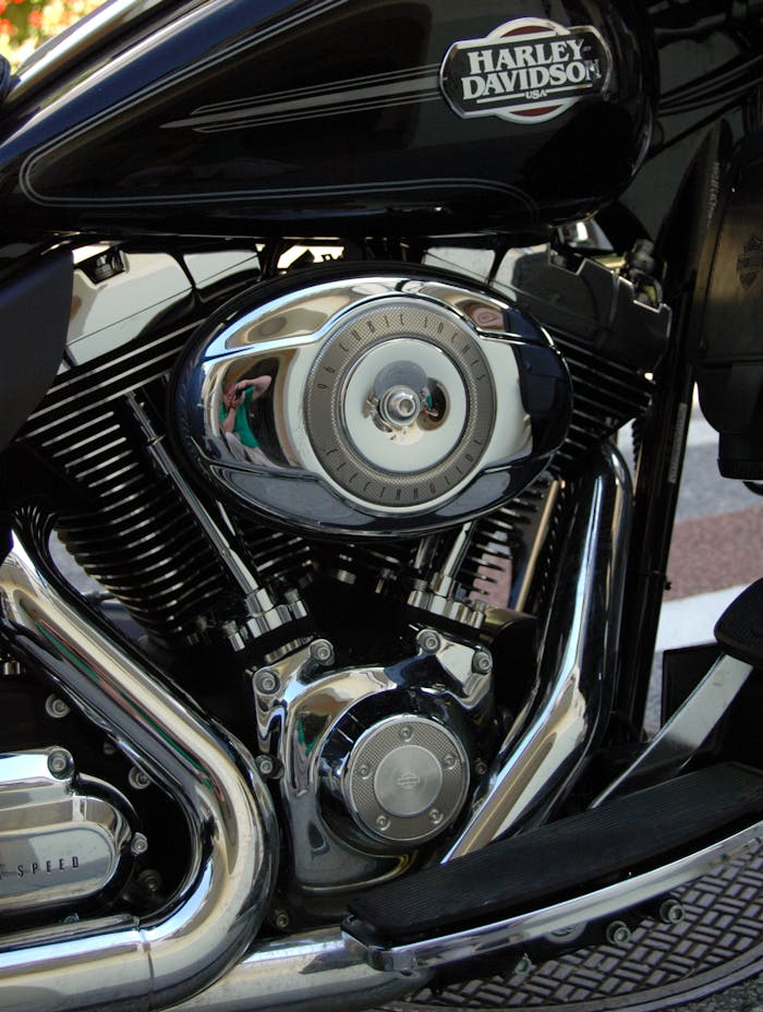 Detailed image of a Harley Davidson motorcycle engine showcasing chrome and classic design.